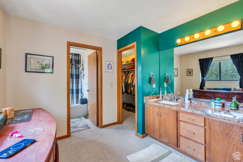 Bathroom with double vanity and shower / bathtub combination with curtain
