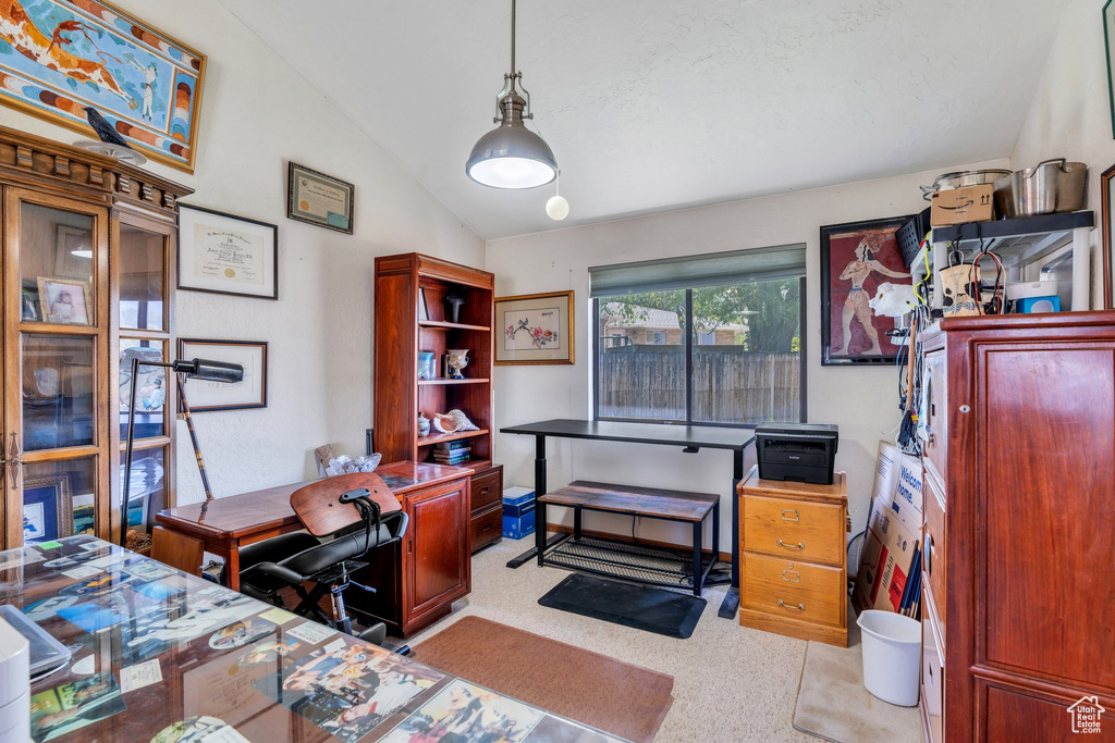 Bedroom with lofted ceiling, a desk, and light colored carpet