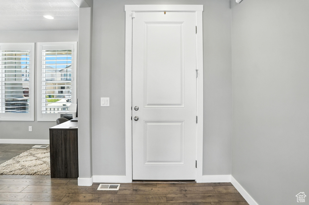 Foyer entrance featuring dark wood-type flooring and recessed lighting
