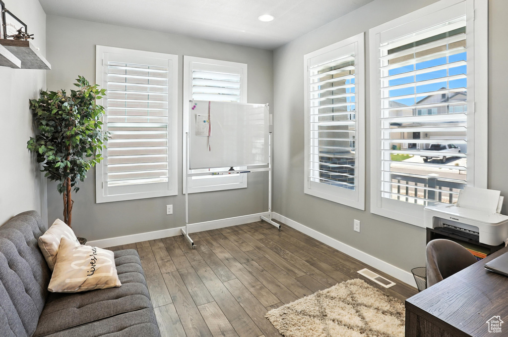 Office area featuring wood finished floors and recessed lighting