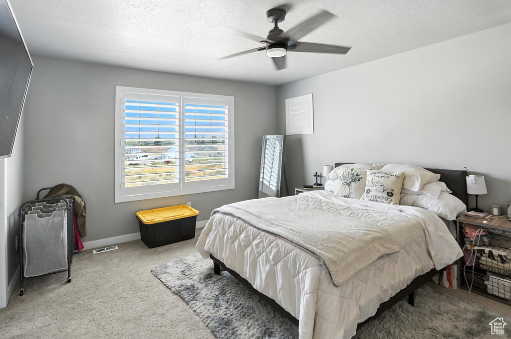 Bedroom with carpet flooring and a ceiling fan