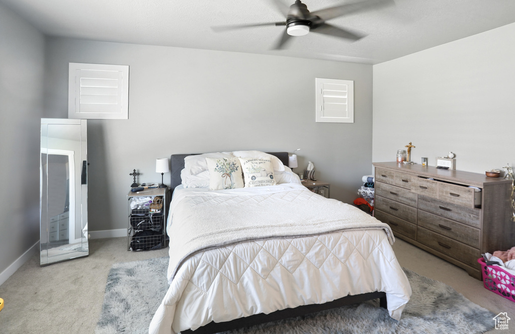 Carpeted bedroom with baseboards and ceiling fan