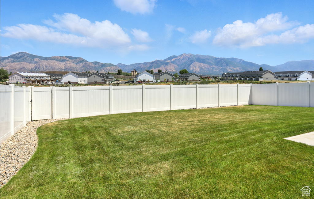 Fenced backyard with a mountain view and a residential view