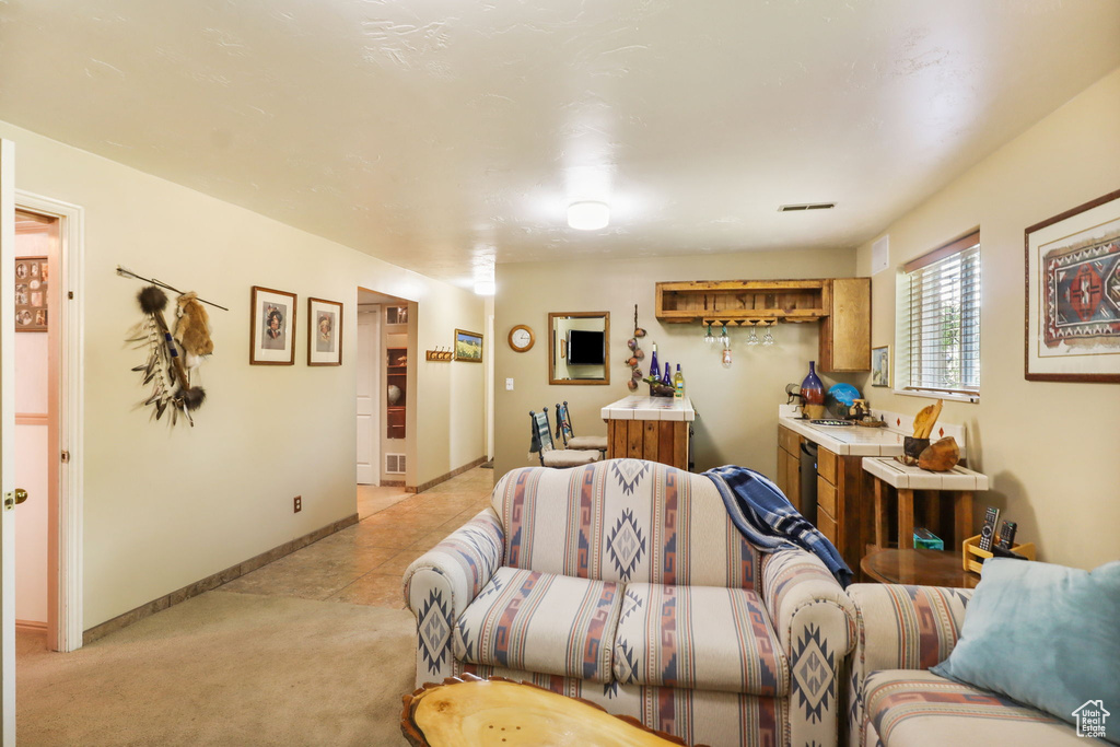 Living area with light carpet and light tile patterned floors