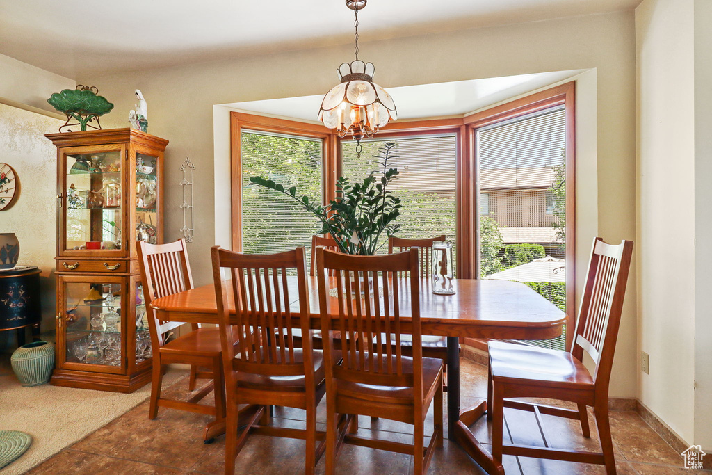 Dining space with a chandelier and baseboards
