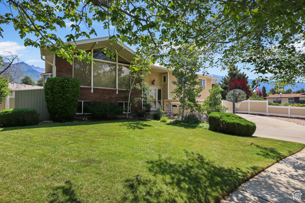 View of front of home featuring a mountain view and brick siding