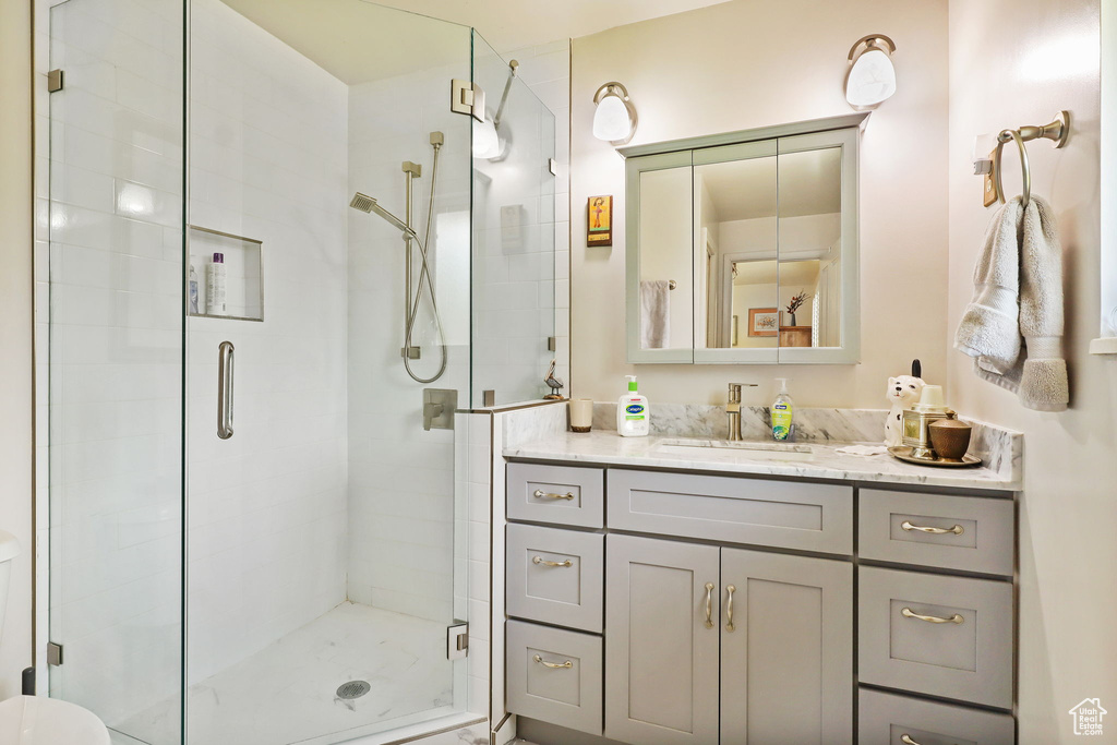 Bathroom featuring vanity and a stall shower