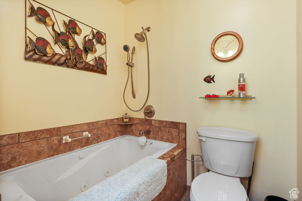 Full bath featuring a tub with jets and toilet