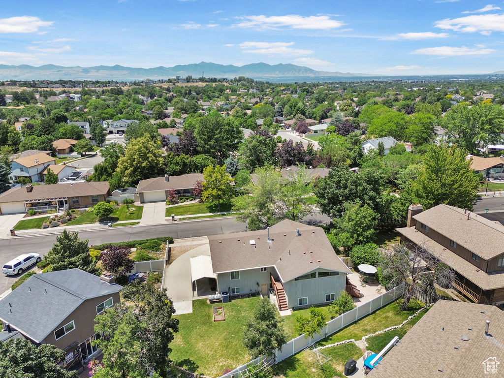 Aerial view of residential area featuring a mountainous background