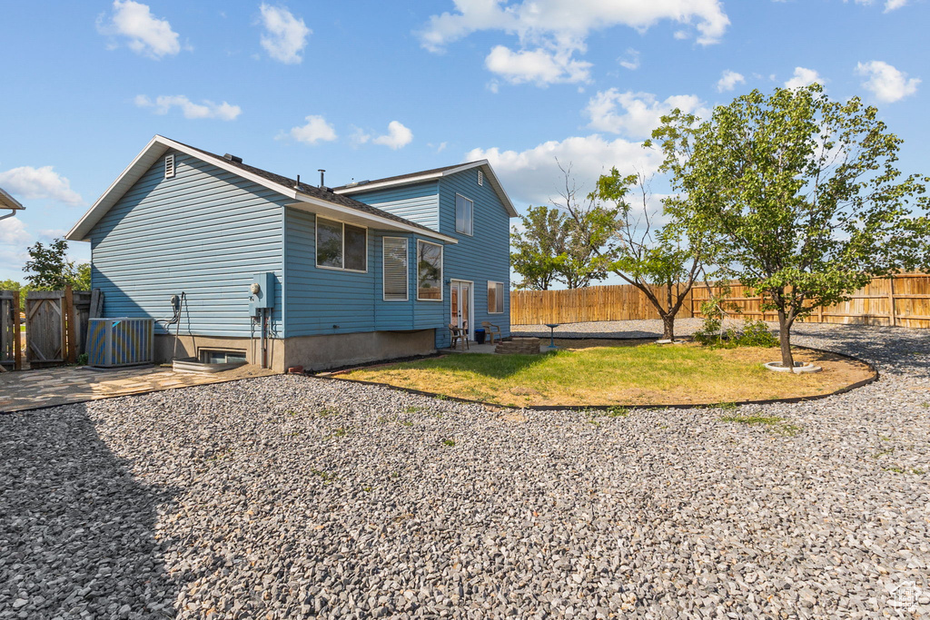 View of home's exterior with a fenced backyard and a patio