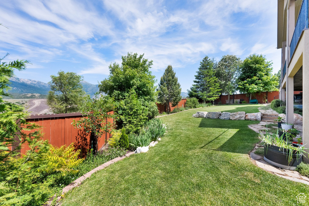 Fenced backyard with a mountain view