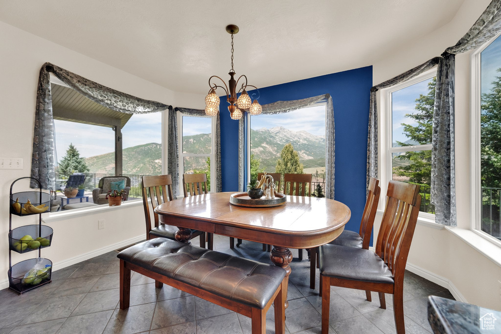 Dining area featuring plenty of natural light, a mountain view, and a chandelier