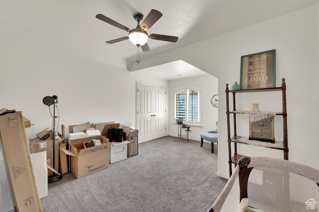 Carpeted office with ceiling fan and baseboards