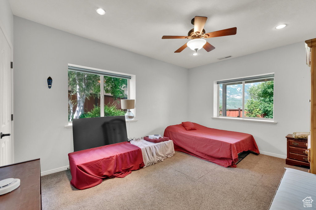 Bedroom featuring multiple windows, carpet flooring, recessed lighting, and a ceiling fan