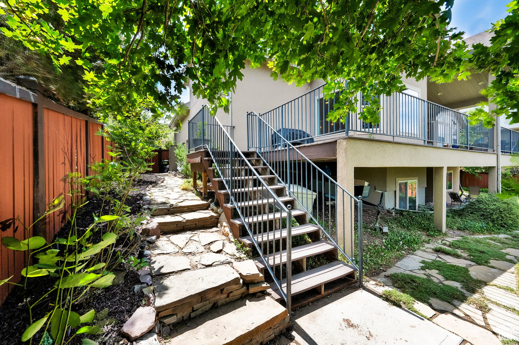 Fenced backyard featuring stairway