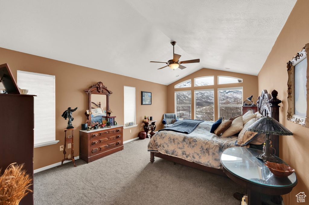 Carpeted bedroom featuring lofted ceiling and ceiling fan