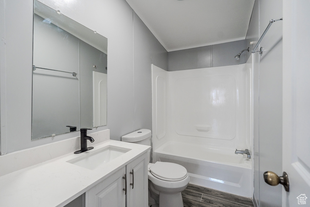 Bathroom featuring vanity, wood finished floors, and shower / tub combination
