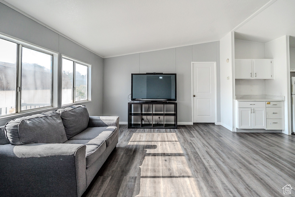 Living area featuring vaulted ceiling and wood finished floors
