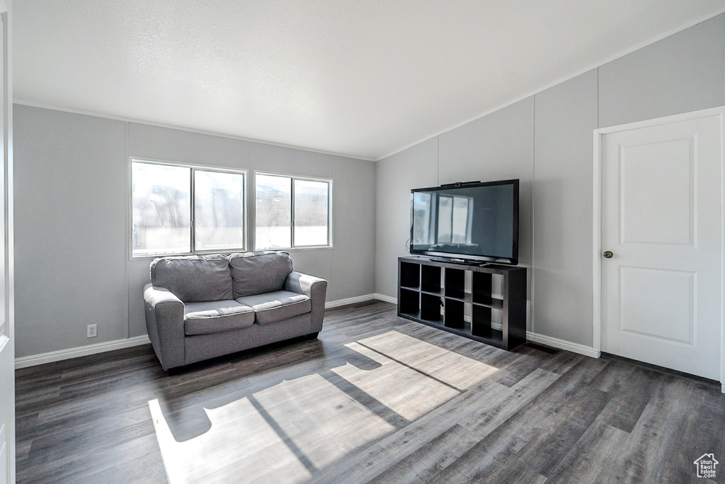 Living area featuring vaulted ceiling and wood finished floors