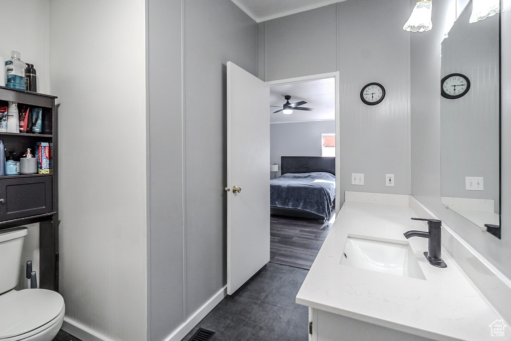 Bathroom with vanity, a ceiling fan, and ensuite bathroom
