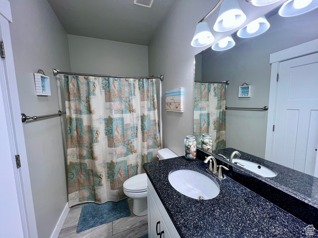 Bathroom featuring vanity and curtained shower
