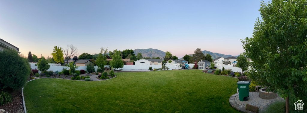 Yard at dusk with a residential view