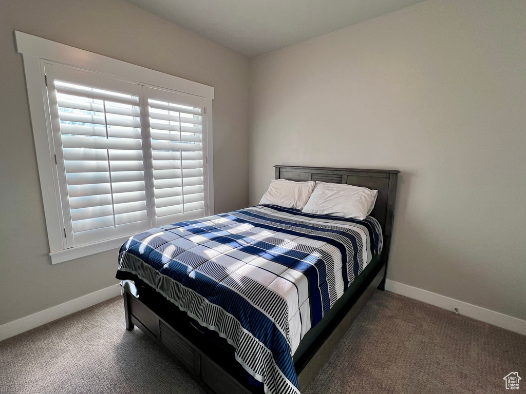 Carpeted bedroom with baseboards