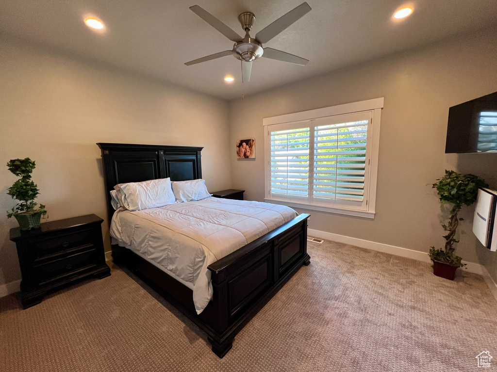 Bedroom featuring light carpet, recessed lighting, and a ceiling fan