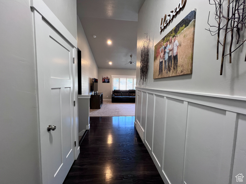 Corridor with dark wood finished floors and recessed lighting