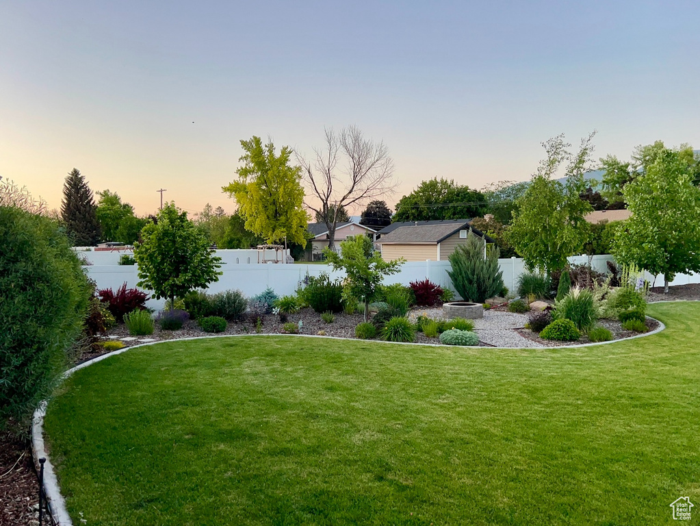 Yard at dusk with a fenced backyard