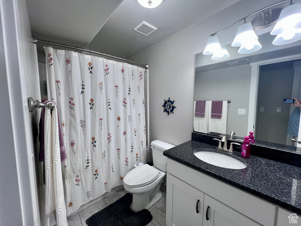 Bathroom with vanity and curtained shower