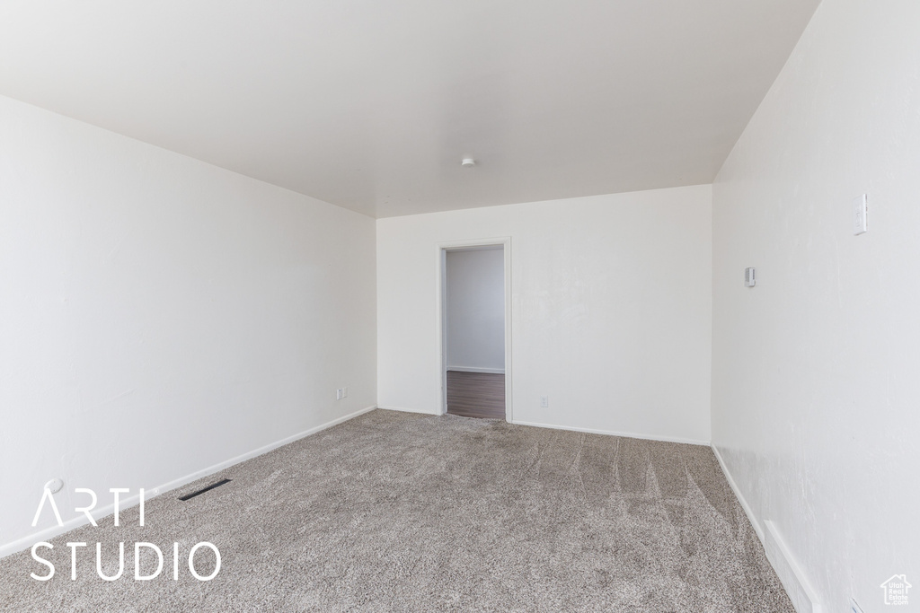 Empty room featuring carpet floors and baseboards
