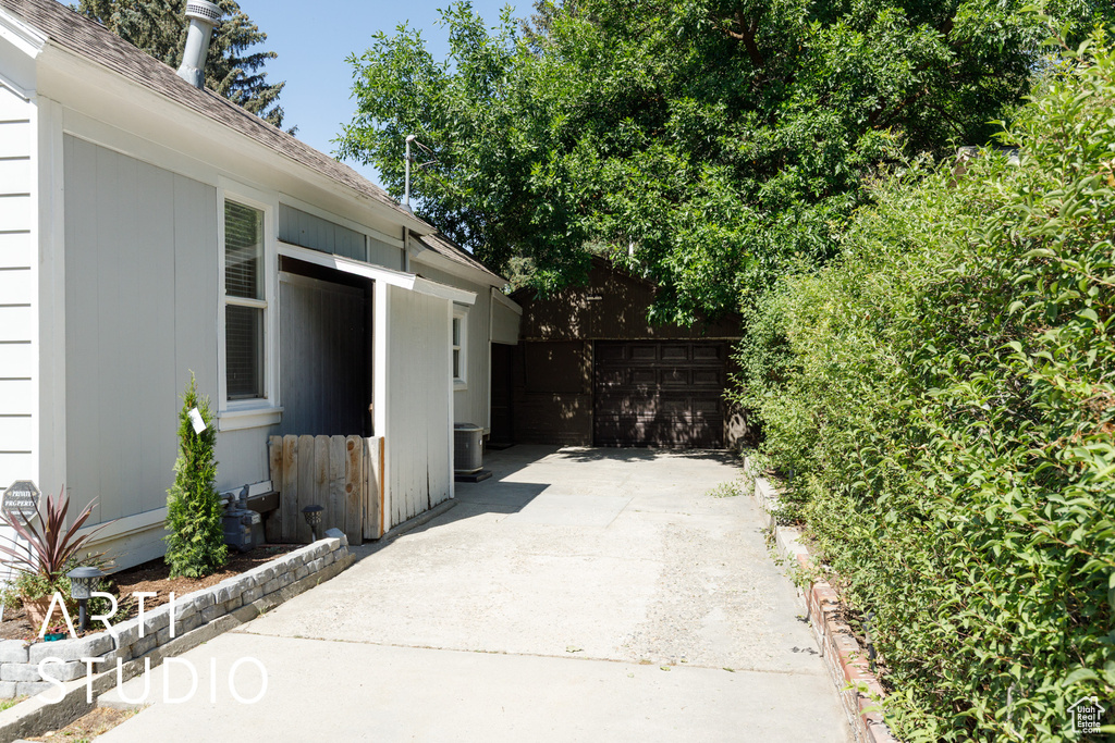 View of patio with driveway and a garage