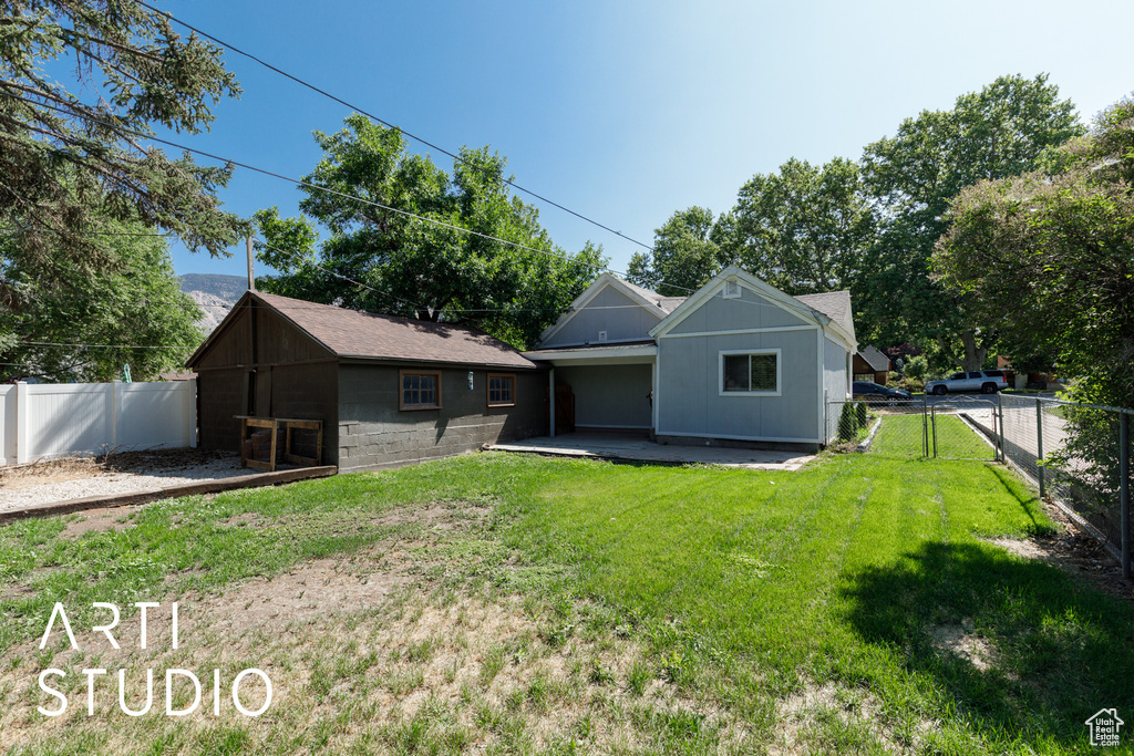 Back of house with a fenced backyard
