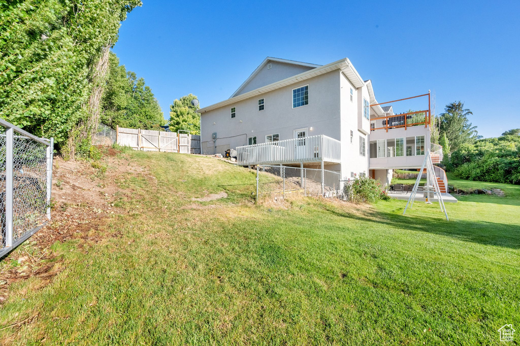 Back of property featuring stucco siding and a deck
