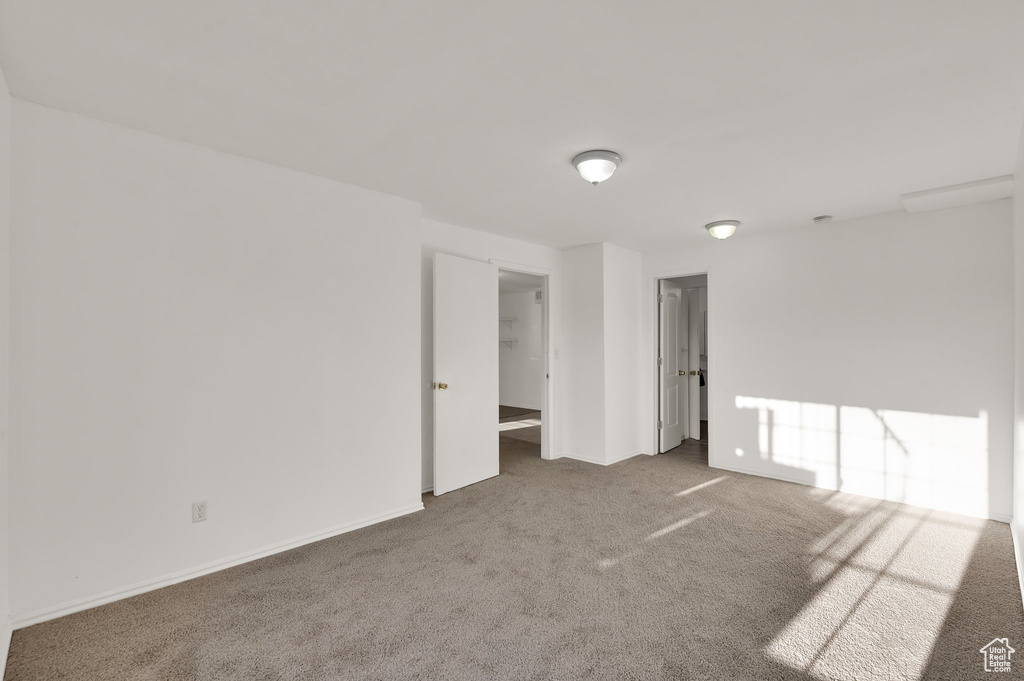 Carpeted empty room with baseboards