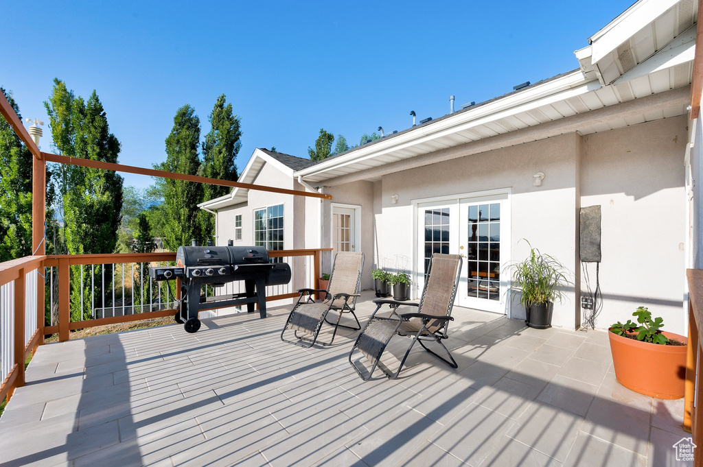 Wooden deck with a grill and french doors