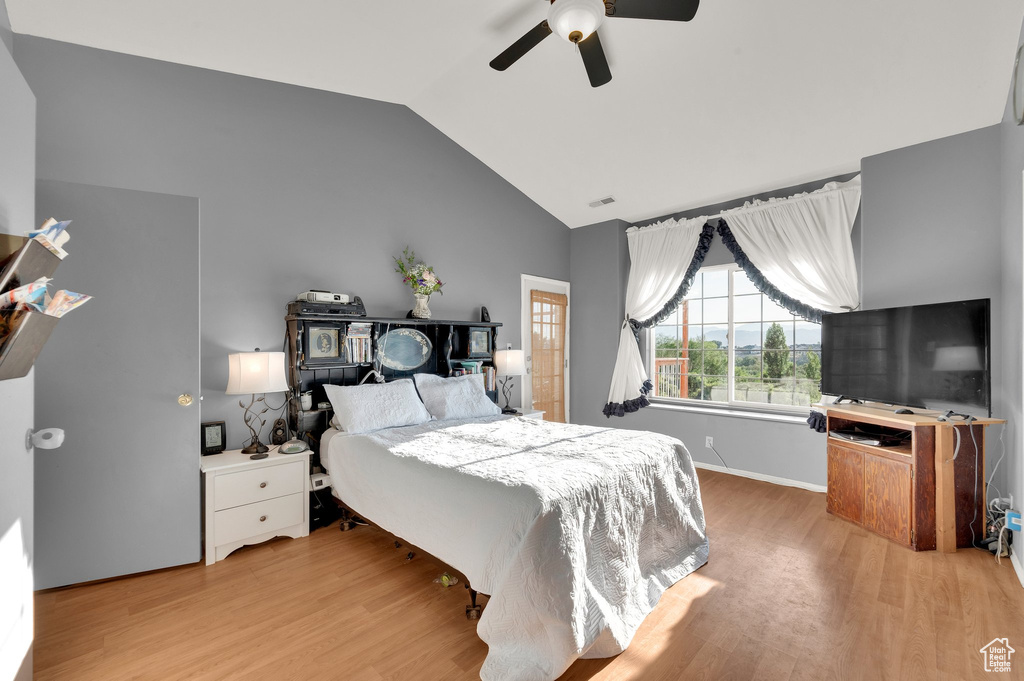 Bedroom featuring lofted ceiling, light wood-type flooring, and a ceiling fan