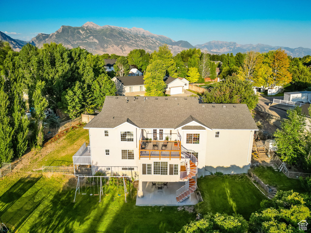 Aerial view of property and surrounding area featuring mountains