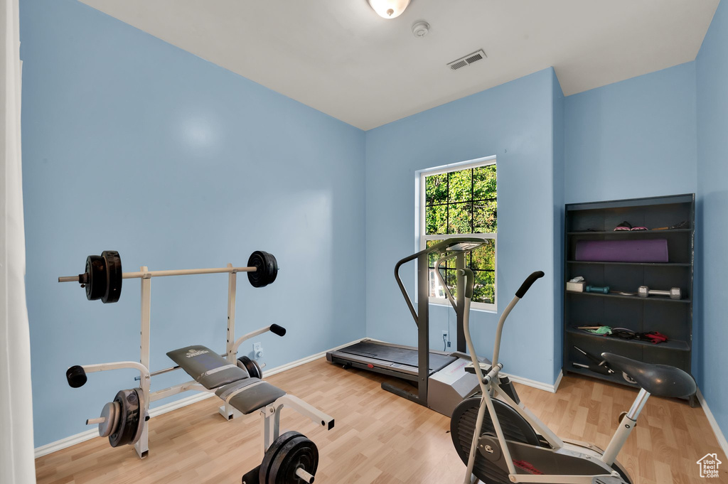 Workout area featuring wood finished floors