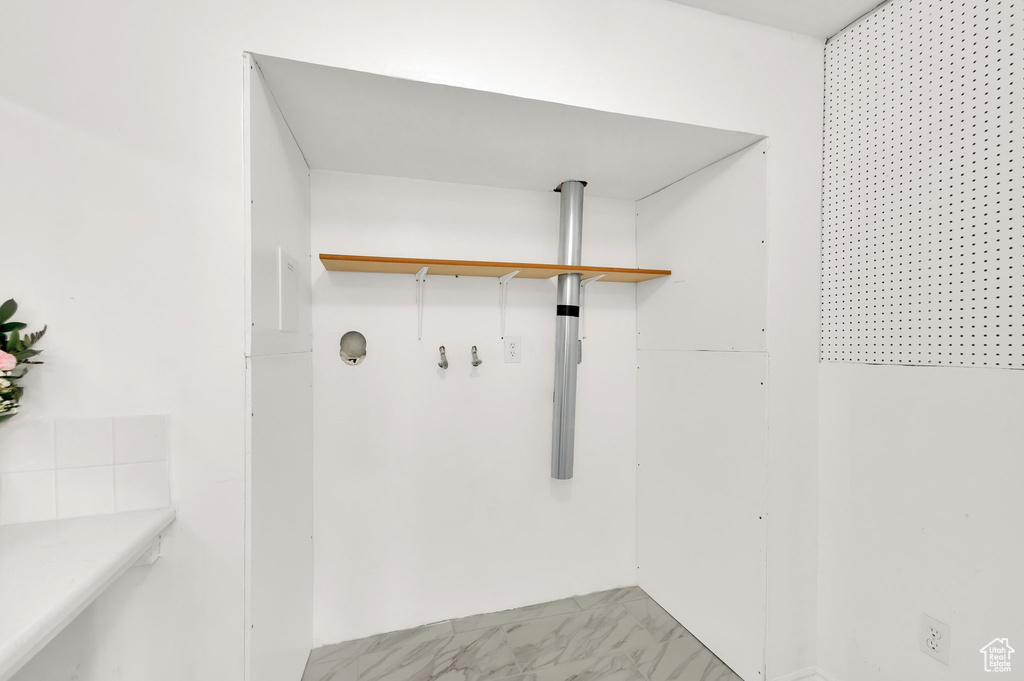 Walk in closet with light marble finish flooring