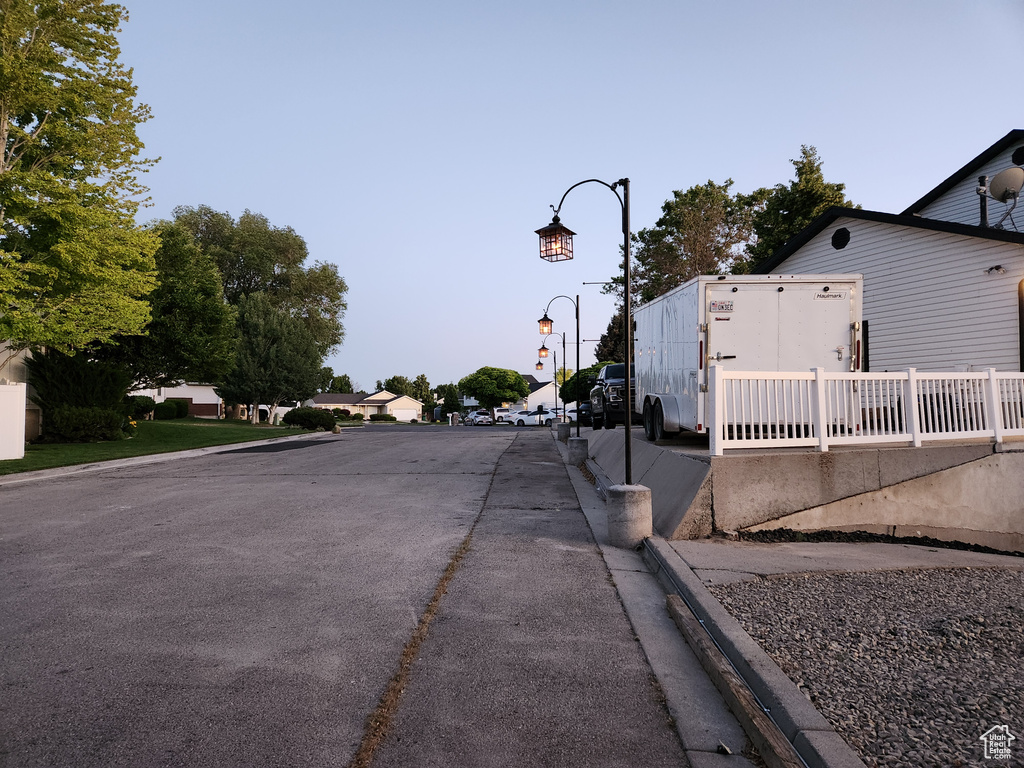 View of asphalt street with street lights and curbs