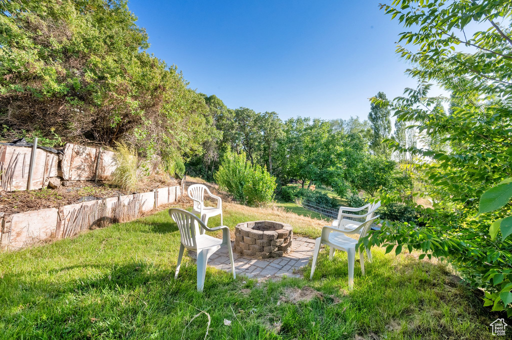View of yard with an outdoor fire pit