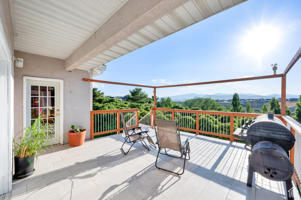 View of patio with grilling area and a mountain view