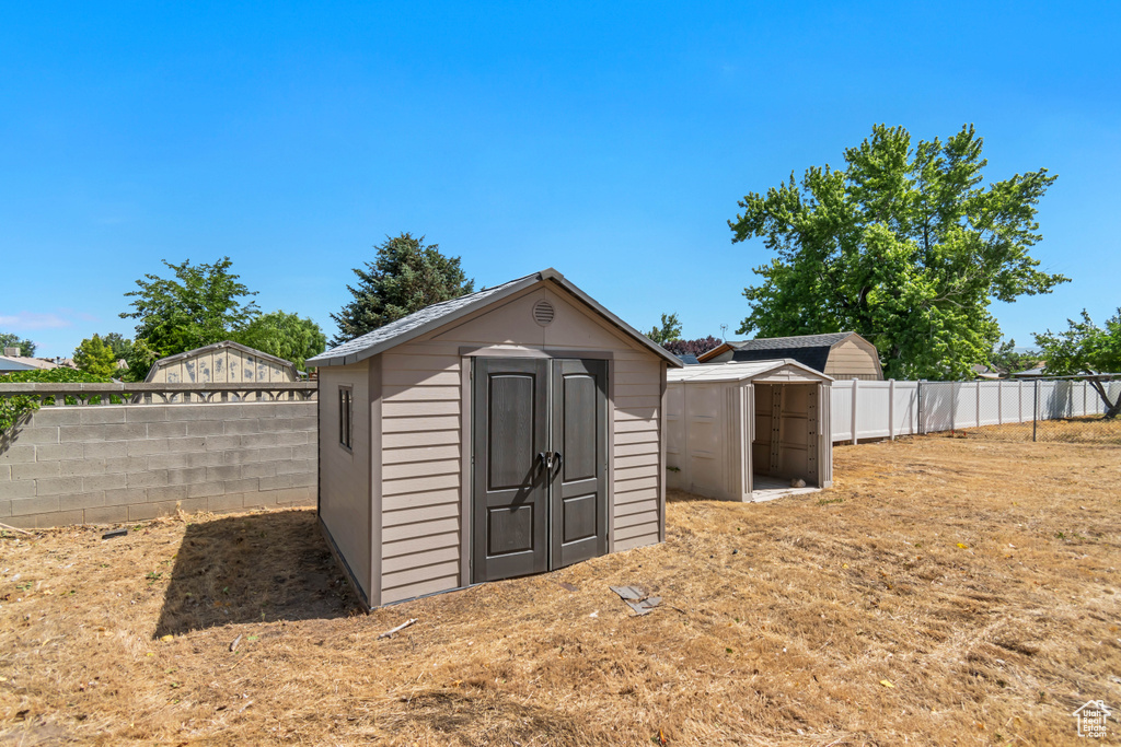 View of shed with a fenced backyard
