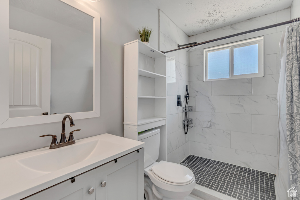 Full bathroom featuring vanity and a tile shower
