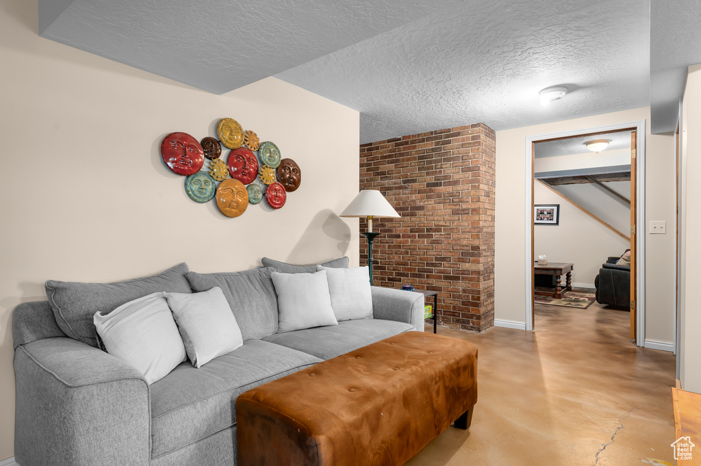 Living room with concrete flooring and a textured ceiling