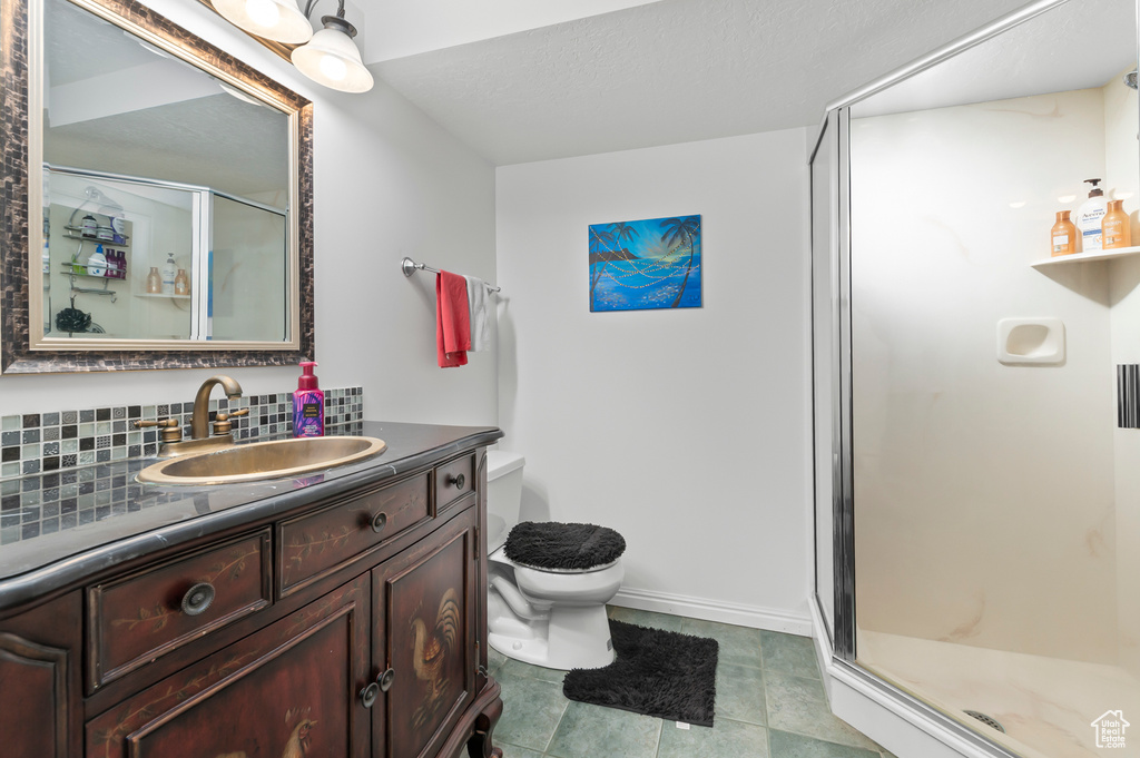 Full bath with a shower stall and vanity