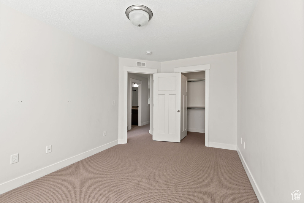 Unfurnished bedroom featuring carpet flooring
