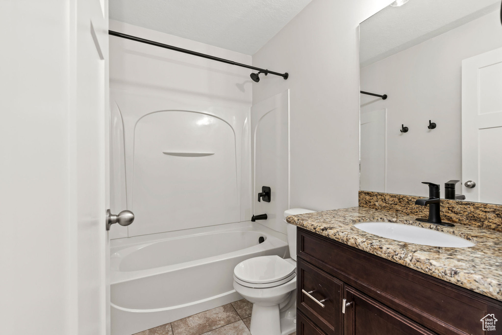 Full bathroom featuring vanity, bathtub / shower combination, and tile patterned flooring